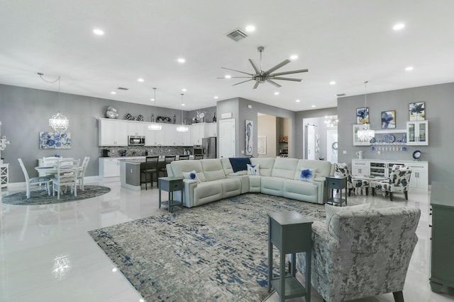 living area with an inviting chandelier, recessed lighting, and visible vents