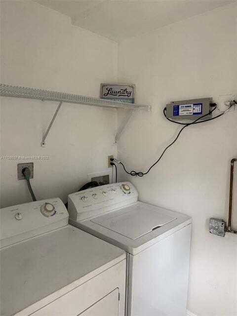 laundry room with washing machine and dryer