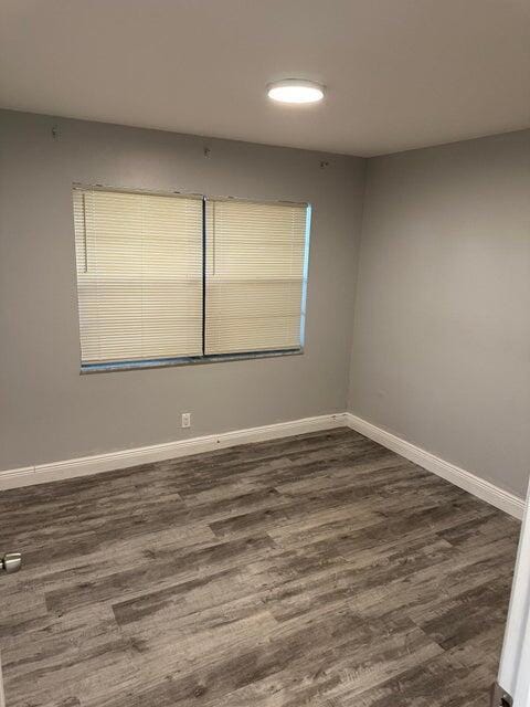 spare room featuring dark hardwood / wood-style floors