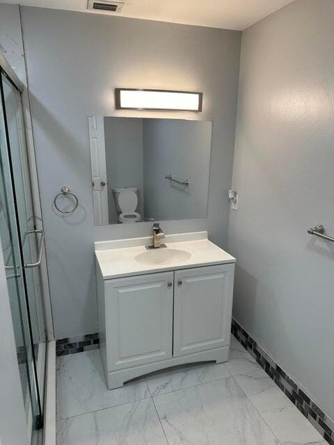 bathroom with vanity and toilet