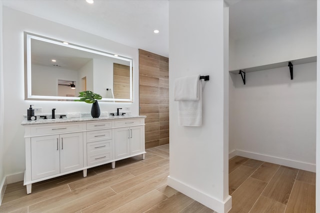 bathroom featuring ceiling fan and vanity