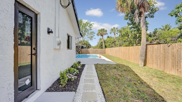 view of yard featuring a patio area and a fenced in pool