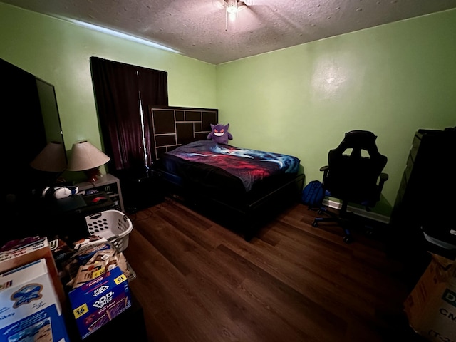 bedroom featuring hardwood / wood-style flooring and a textured ceiling