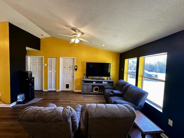 living room with lofted ceiling, dark hardwood / wood-style floors, a textured ceiling, and ceiling fan