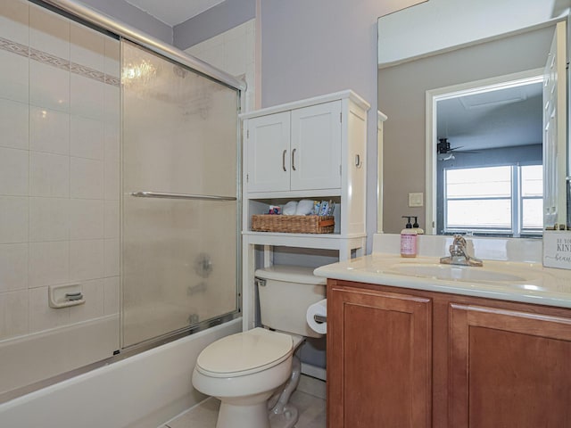 full bathroom with toilet, shower / bath combination with glass door, vanity, ceiling fan, and tile patterned flooring