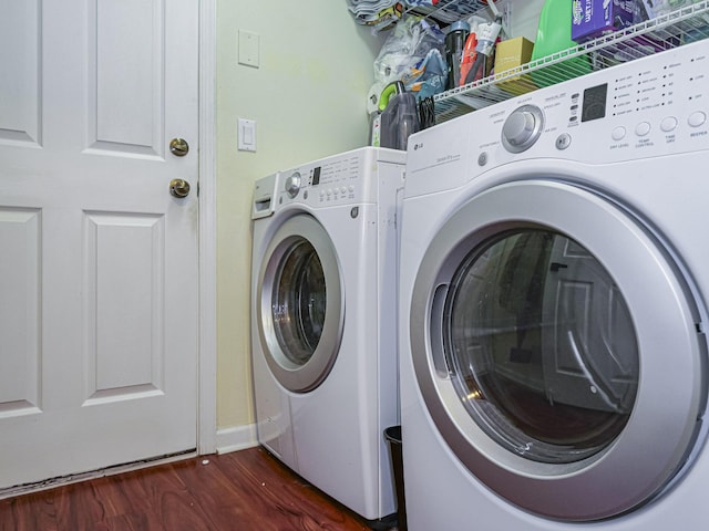 laundry room featuring dark hardwood / wood-style flooring and washer and dryer