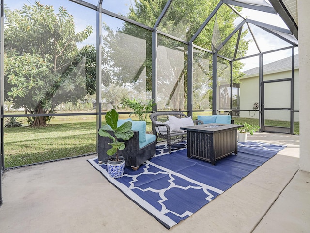 view of patio with an outdoor living space with a fire pit and glass enclosure