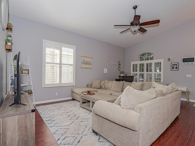 living room with lofted ceiling, hardwood / wood-style floors, and ceiling fan