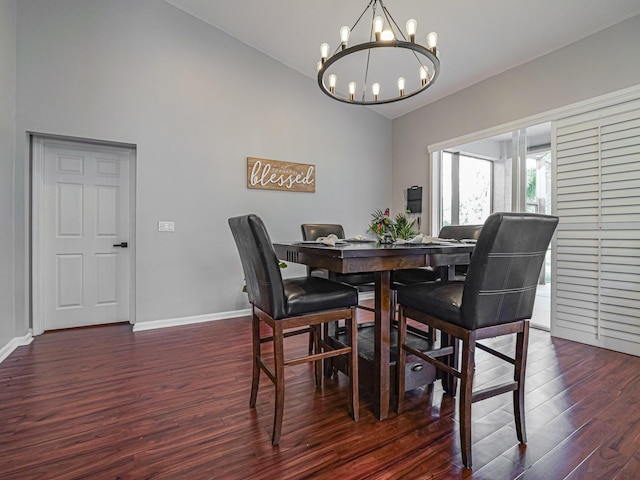 dining space with an inviting chandelier, dark wood-type flooring, and vaulted ceiling