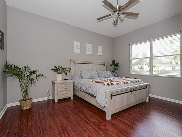 bedroom with ceiling fan and dark hardwood / wood-style floors