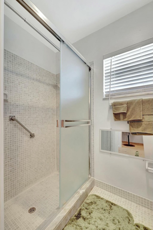 bathroom featuring walk in shower and tile patterned floors