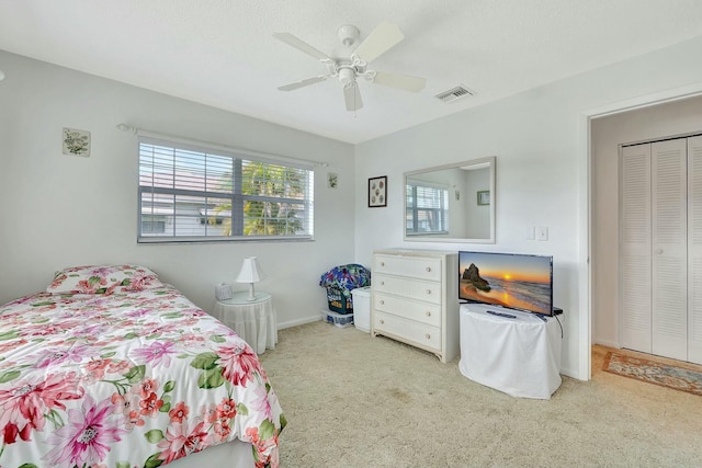 bedroom featuring light carpet and ceiling fan