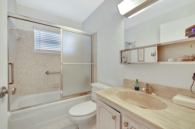 full bathroom with enclosed tub / shower combo, vanity, and toilet