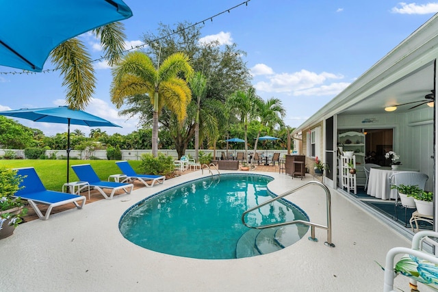 view of pool with a yard, ceiling fan, and a patio area