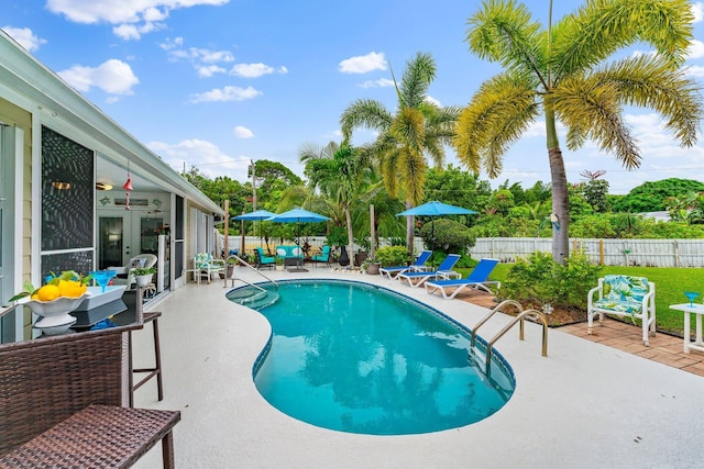 view of swimming pool featuring ceiling fan and a patio