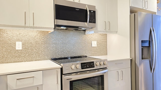 kitchen featuring white cabinets, stainless steel appliances, and backsplash