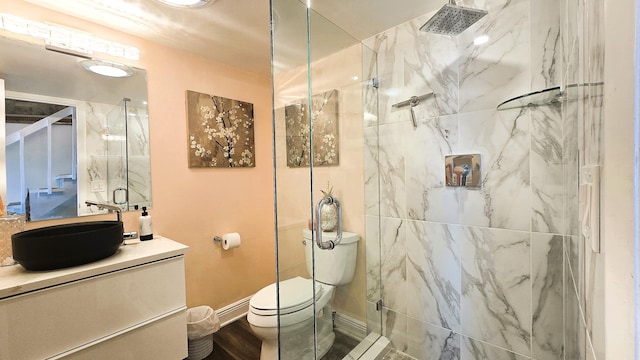 bathroom featuring toilet, wood-type flooring, vanity, and walk in shower