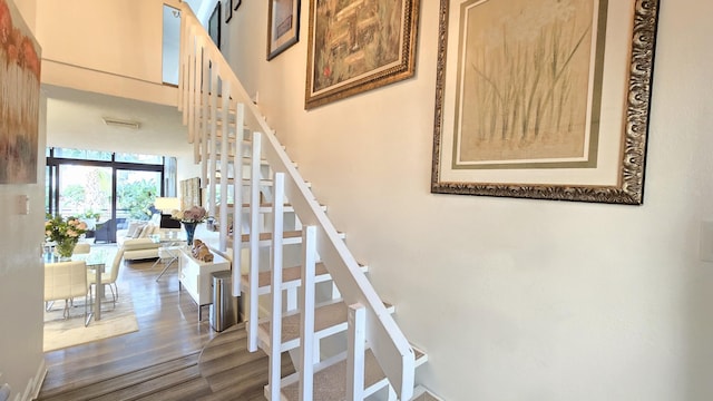 stairway featuring wood-type flooring