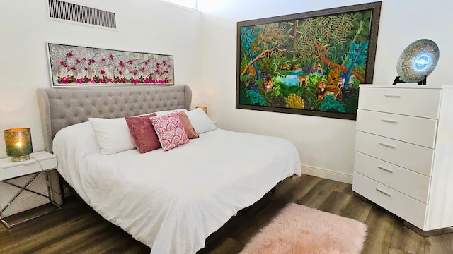 bedroom with dark hardwood / wood-style flooring