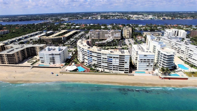 bird's eye view featuring a water view and a beach view