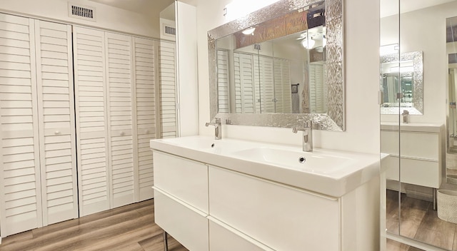 bathroom with vanity and hardwood / wood-style floors