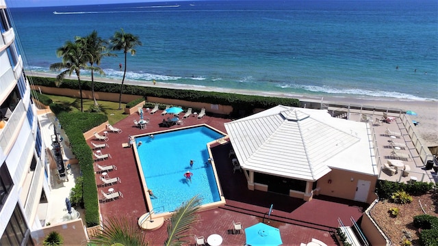 birds eye view of property with a water view and a view of the beach