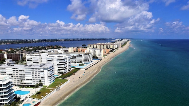 aerial view with a water view and a beach view