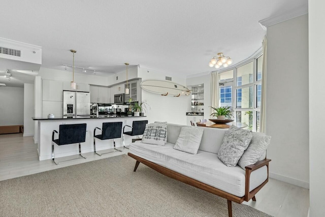 living room featuring sink, crown molding, a wall of windows, and a textured ceiling