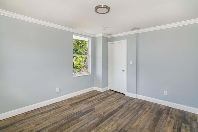 unfurnished room featuring ornamental molding and dark hardwood / wood-style floors