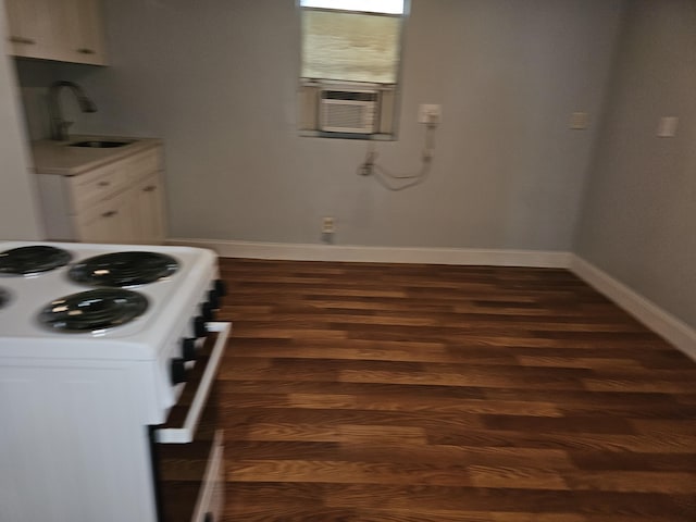 kitchen with white cabinetry, sink, white electric range, and cooling unit