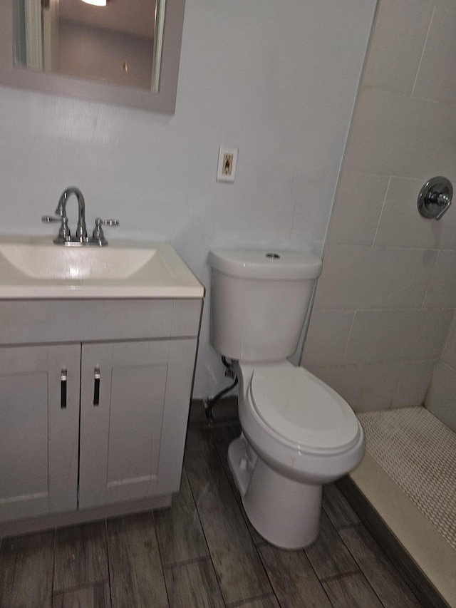 bathroom featuring vanity, a shower, and toilet