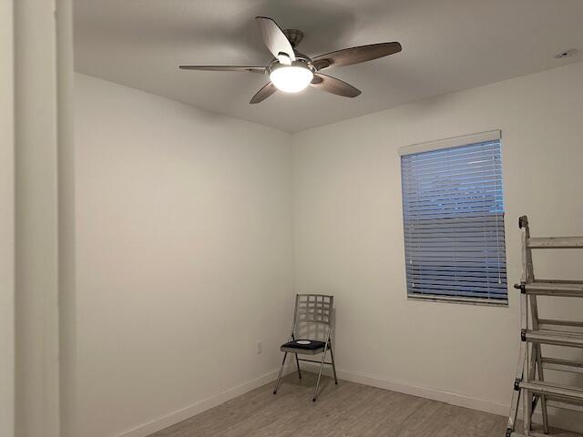 empty room featuring ceiling fan and light wood-type flooring