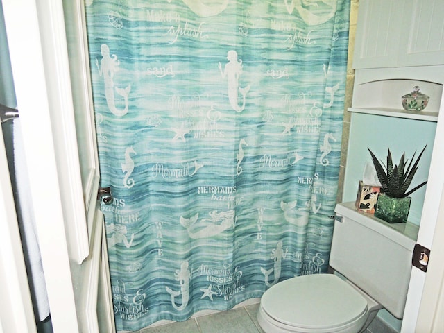 bathroom with toilet and tile patterned flooring