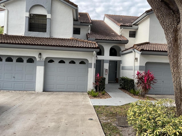 mediterranean / spanish home with a garage