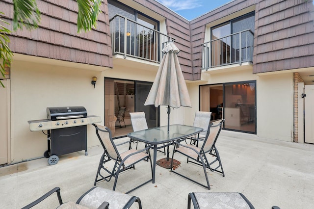 view of patio / terrace with grilling area and a balcony