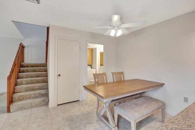 dining space with washing machine and dryer, ceiling fan, and light tile patterned flooring