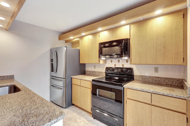 kitchen featuring light brown cabinetry, black electric range, and stainless steel fridge