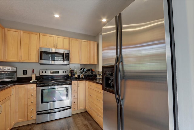 kitchen featuring stainless steel appliances, dark hardwood / wood-style flooring, and light brown cabinetry