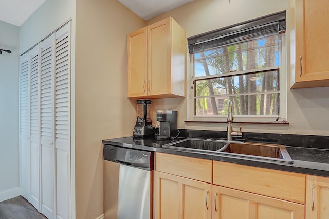 kitchen featuring dishwasher, light brown cabinets, and sink