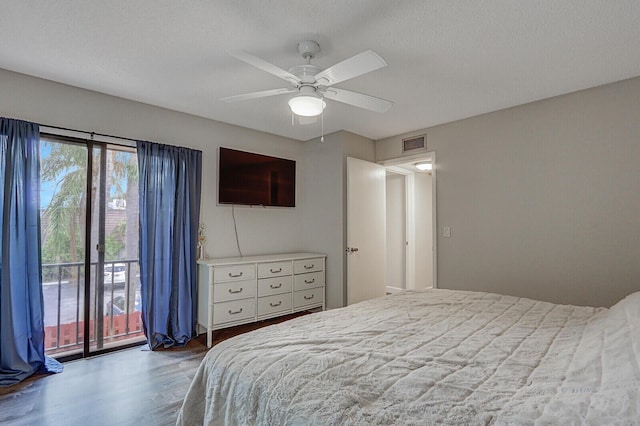 bedroom with a textured ceiling, access to exterior, ceiling fan, and wood-type flooring