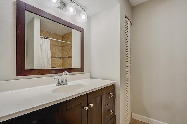 bathroom with curtained shower and vanity