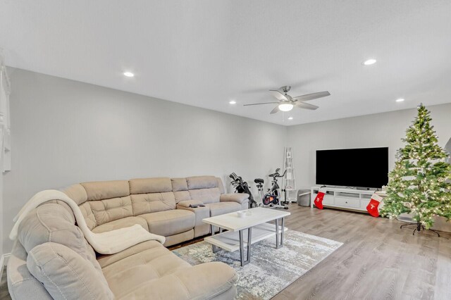 living room with light wood-type flooring and ceiling fan