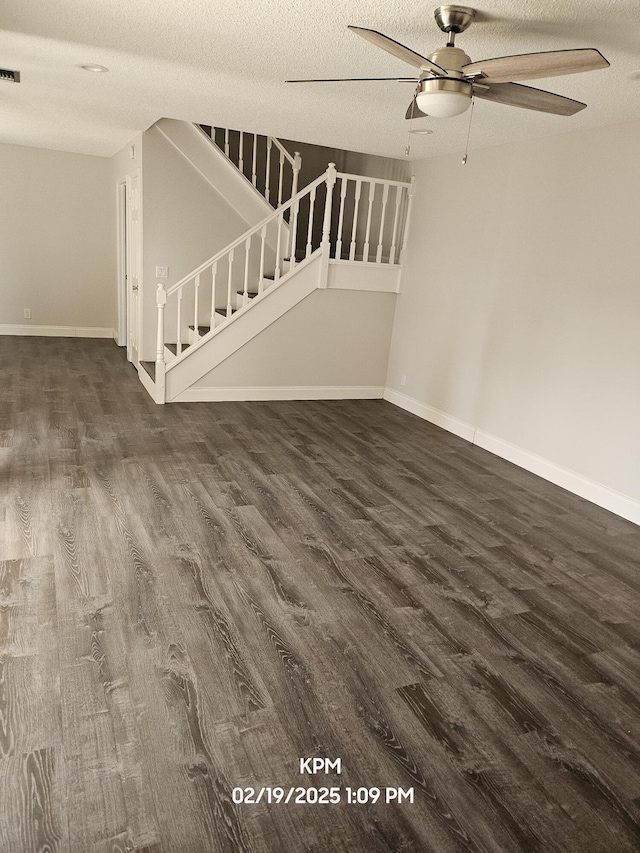 unfurnished living room featuring a textured ceiling, ceiling fan, and dark hardwood / wood-style floors