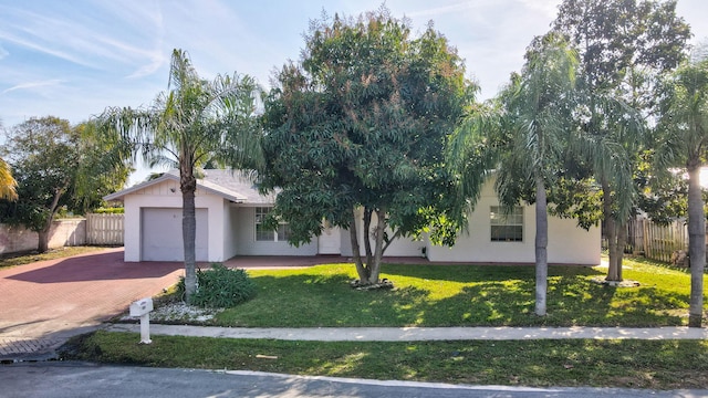 view of front of home with a garage and a front yard