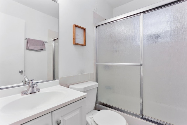 full bathroom with vanity, shower / bath combination with glass door, and toilet