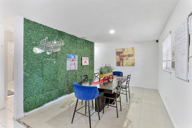 dining room featuring tile patterned floors and a textured ceiling