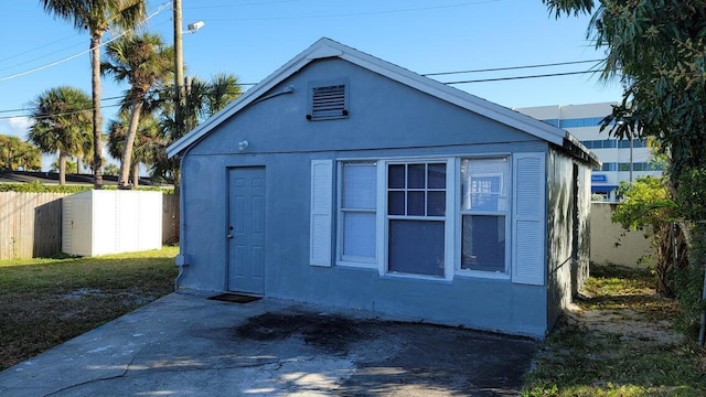 view of side of home featuring an outbuilding