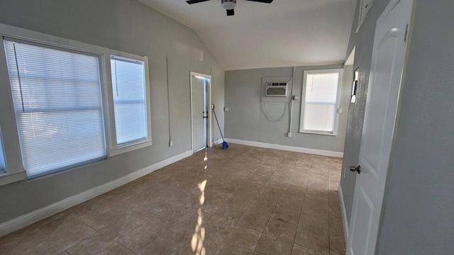 tiled empty room with ceiling fan, lofted ceiling, and a wall mounted air conditioner