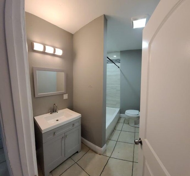 bathroom with vanity, tile patterned flooring, toilet, and walk in shower