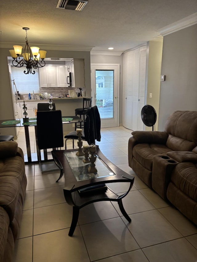 living room featuring ornamental molding, a chandelier, and light tile patterned floors